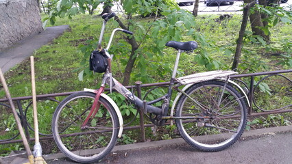 Fototapeta premium Janitor's bike in the city yard