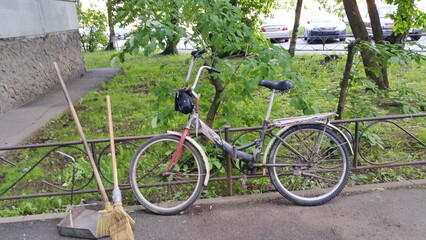 Fototapeta premium Janitor's bike in the city yard