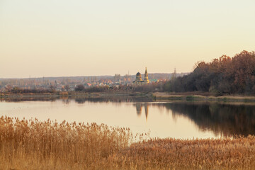 View of autumn lake and  church with domes
