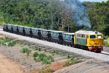 Hopper-freight train by diesel locomotive on the railway in Thailand