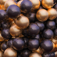 abstract background with black purple and gold golf balls.