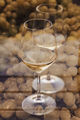 Image overlay of white grapes and two wine glasses on a wooden table