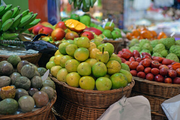Market with fruits and vegetables in baskets. Lots of colorful fruits at the bazaar. Selling and trading. 