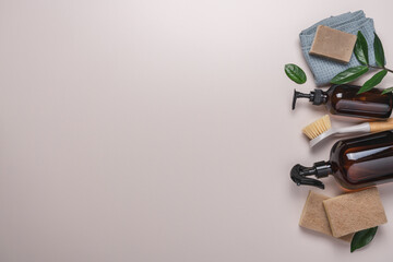 Zero waste aesthetic, housekeeping  cleaning equipment. Eco detergents in glass bottles, brushes, rags, sponges on light background