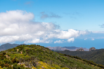 View on lookout Mirador Morro de Agando surrounded by laurel forest near Roque de Agando, Garajonay National Park on La Gomera, Canary Islands, Spain, Europe. Pico del Teide on Tenerife hiding