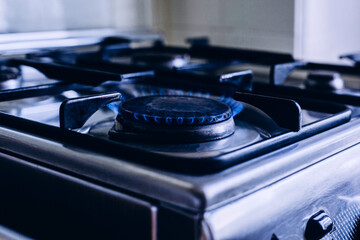 Kitchen gas hob, stove cook with blue flames burning - obrazy, fototapety, plakaty