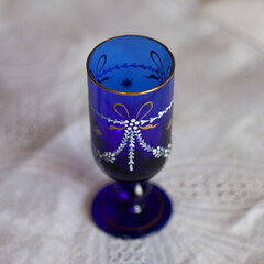 antique glass decanter in blue color in a luxurious interior. blue glass close-up