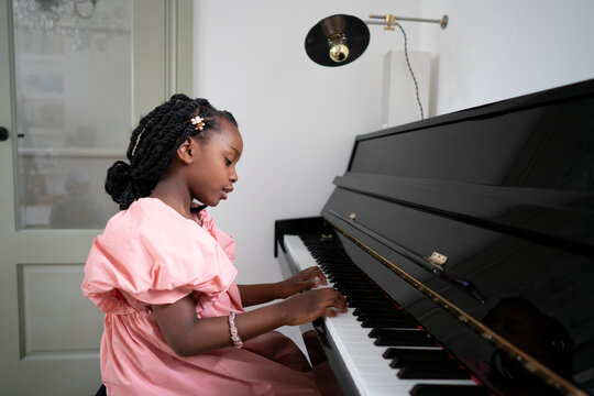 Girl (6-7) playing piano