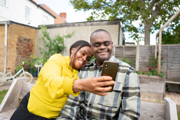 Mother and adult son with Down syndrome taking selfie