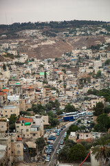 Vertical photograph of an urban slum in Israel. Dense urban development and garbage. Street passing through the houses with a view from above. Jerusalem buildings