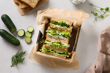 Homemade English tea cucumber sandwiches with ricotta and dill on white background. Close up....