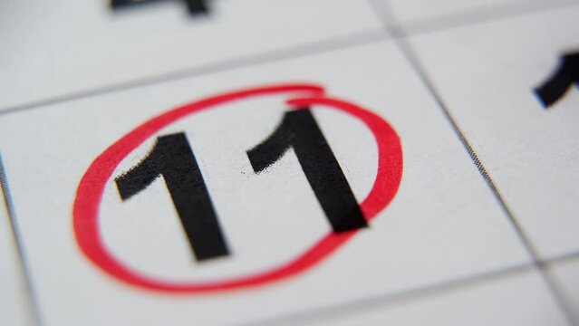 The calendar 11th day of the month is circled. A red marker circles the eleventh day of the month from the paper calendar. A very important date in the calendar