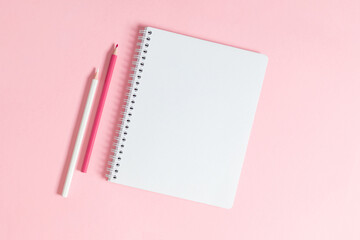 Back to school background. Flat lay, top view of colorful scattered stationery on isolated pastel light pink table background. School supplies on desk. Copyspace.