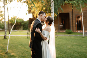 young couple the groom in a black suit and the bride in a white short dress