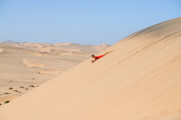 Fototapeta na wymiar Sand boarding in Namibia
