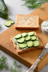 Cooking traditional English tea cucumber sandwiches with ricotta and dill for breakfast. Close up. Crispy freshness cold summer appetizer.
