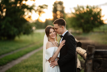 young couple the groom in a black suit and the bride in a white short dress