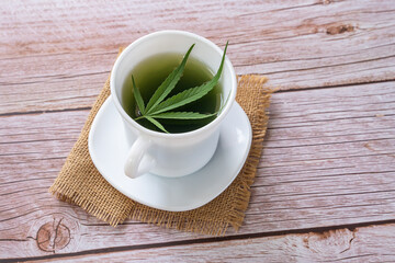 Fresh cannabis smoothie on wooden background. Concept edibles CBD and drinks with cannabis, hemp..