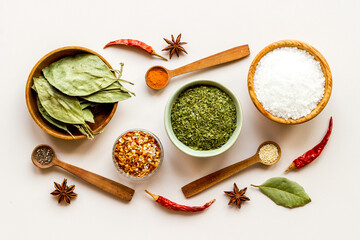 Cooking ingredients - colorful spices and herbs in bowls, top view