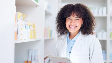 Happy chemist smiling and laughing, stocktaking in a drugstore and using a tablet for online customer orders. Young pharmacist packing chronic medicine and prescription medication on pharmacy shelves