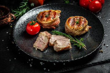 beef filet Mignon steak on plate with pepper and salt, filet mignon. beef tenderloin steaks wrapped in bacon and thyme. top view