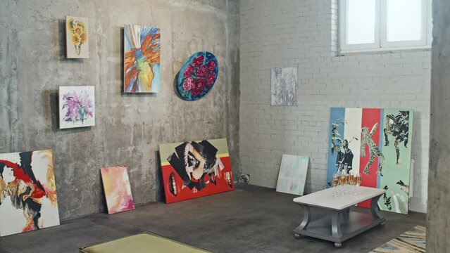 View of abstract paintings and artworks in contemporary art gallery at daytime