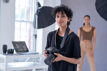 Portrait of female photographer at photo shoot
