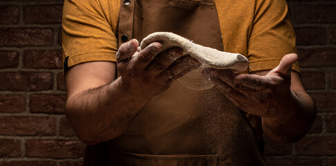 Cook hands kneading dough. Beautiful and strong men's hands knead the dough make bread, pasta or...