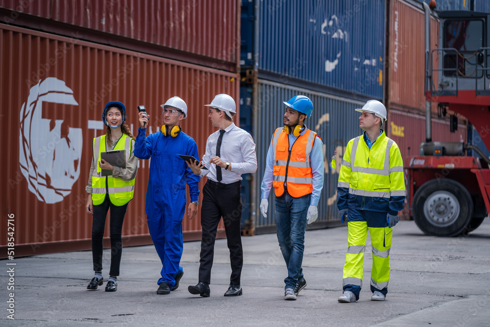 Poster Engineer and foreman team in hardhat checking stock into container for loading from cargo at container yard,Import export shipping concept.