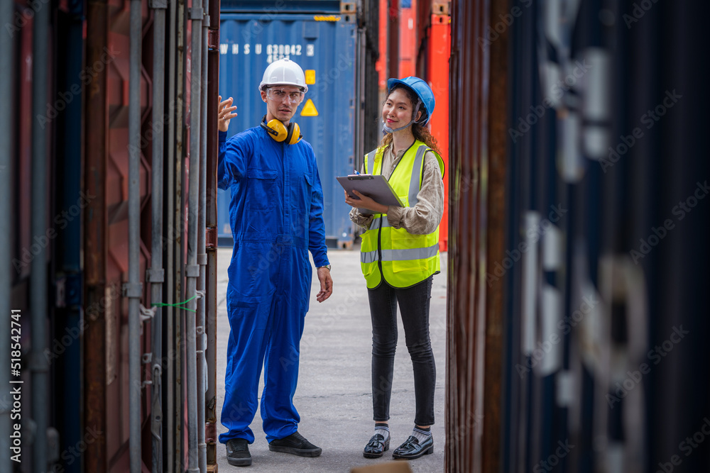Poster Manager and Technicians working checking stock into container for loading at container yard warehouse.