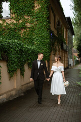 Fototapeta premium young couple bride and groom in a white short dress