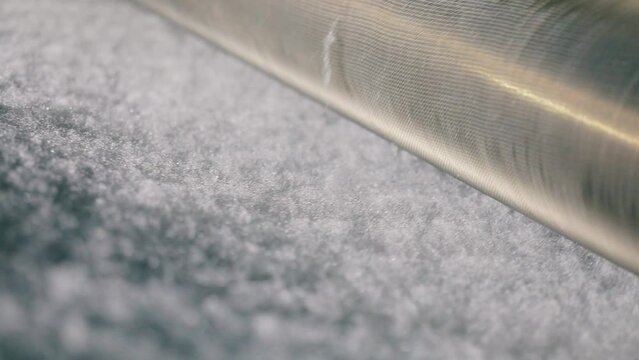 Factory for the production of synthetic winterizer. Syntepon manufacturing process. Production of non-cane materials close-up.
