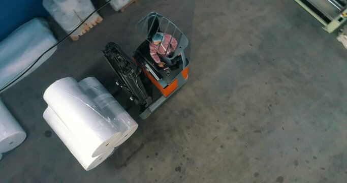 The forklift transports rolls of agrofibre. The forklift transports non-woven materials.