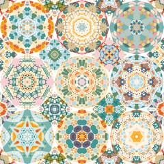 Abstract geometric ornament with stylized mandalas in green, blue, soft pink and orange colors. Seamless print for fabric, wallpaper, ceramic tiles.