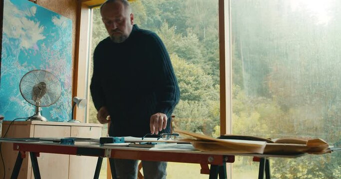 Clearing up artist desk for new charcoal canvas project inception