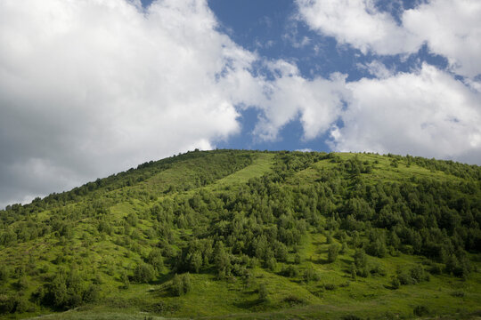 green mountains with cloudy sky background . North Ossetia Alania , Russia