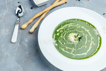 Green cream soup of spinach and broccoli with parmesan, Vegetarian dish. healthy food and diet