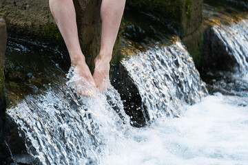 Feet cooling down in cold water of river