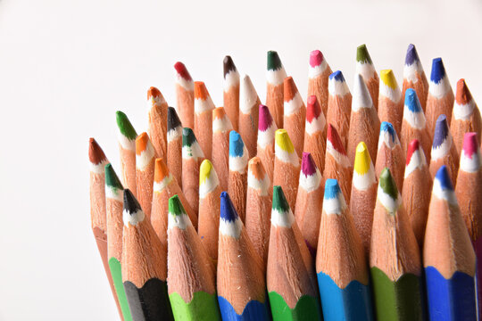 Detail of group of crayon tips on white background