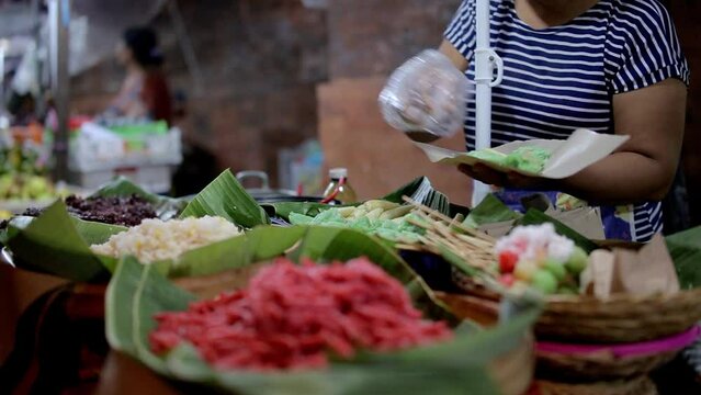 Traders in the market selling traditional snacks, Balinese Indonesian Traditional Snacks, Traditional Cake, Rice Cake in Night Market, Bali, Indonesia, Jajanan Pasar, Jajan Pasar
