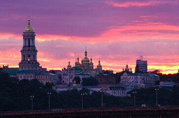 Fototapeta premium Scenic landscape view of ancient Kyiv Pechersk Lavra. Christian Orthodox monastery. UNESCO World Heritage Site. Stormy sky and gloomy clouds. Famous touristic place and travel destination in Kyiv
