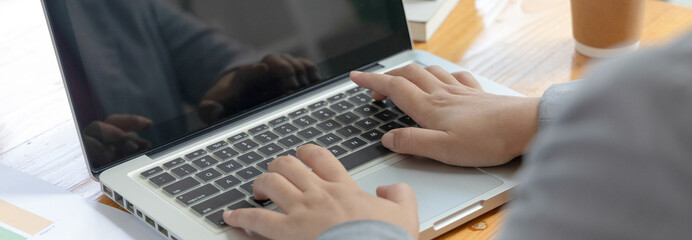 Businesswoman's hand presses on a laptop keyboard, Using computers to conduct financial transactions because the convenience and speed, World of technology and internet communication.