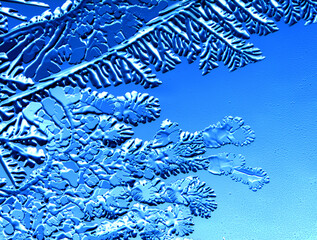 Drawings of ice on blue glass.