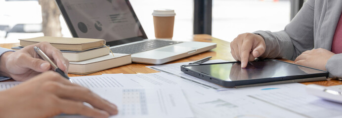 Brainstorm team, Marketers and financial accountants are discussing and analyzing charts to plan strategies to meet customer needs, Using graphs and tablet to analyze business data, Meeting concept.