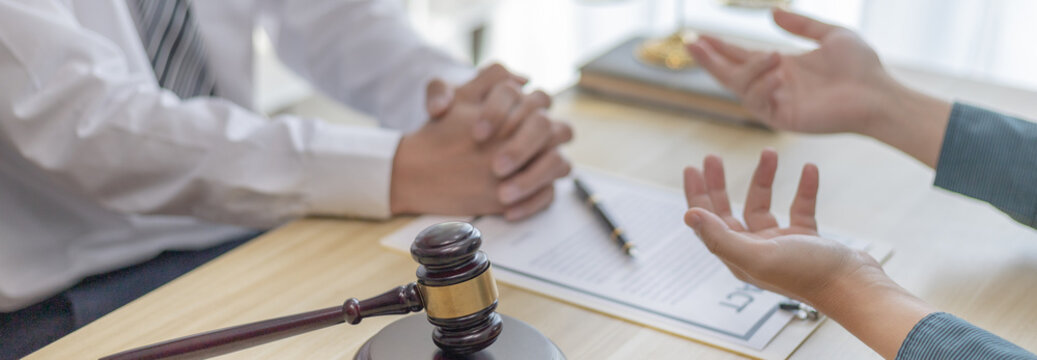 Client describes the money fraud problem and discusses the solution with a lawyer in the litigation room, Ethics in the courts include justice, legal consultant, Scales of justice, Litigation..