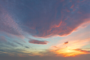Naklejka na ściany i meble Dramatic dawn sky. The sun shines through colored clouds.