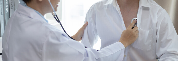 Male doctor uses a stethoscope to check his breathing and lung health to check the patient's...