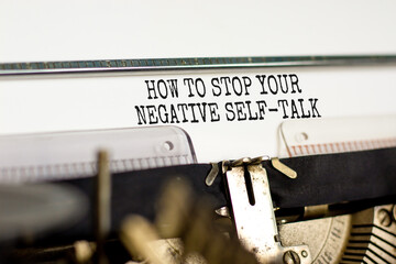Stop negative self-talk symbol. Concept words How to stop your negative self-talk typed on old retro typewriter. Beautiful white background. Psychological stop negative self-talk concept. Copy space.
