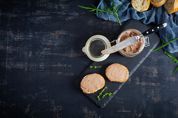 Sandwich with chicken liver pate on dark background. Top view