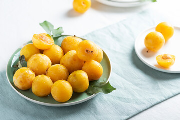 Fresh sweet yellow plums on the table